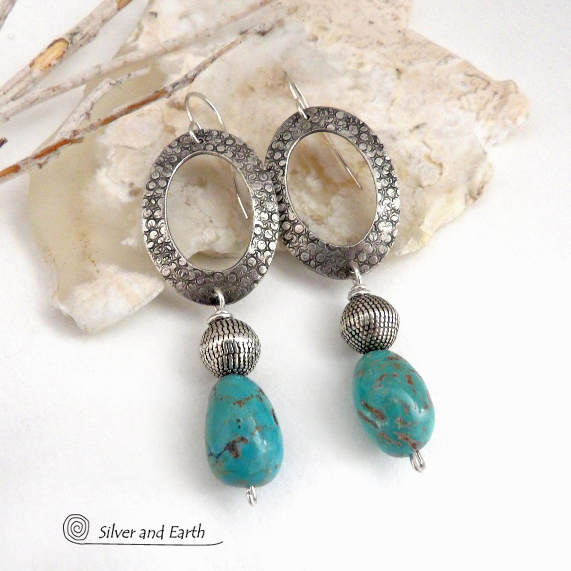 These handcrafted earrings feature hand stamped sterling silver oval hoops accented with natural turquoise stone nuggets and textured silver plated beads. They have a chic modern style with touch of southwestern flair that will coordinate beautifully with all wardrobe types. Handmade in the USA by Silver and Earth Jewelry. 