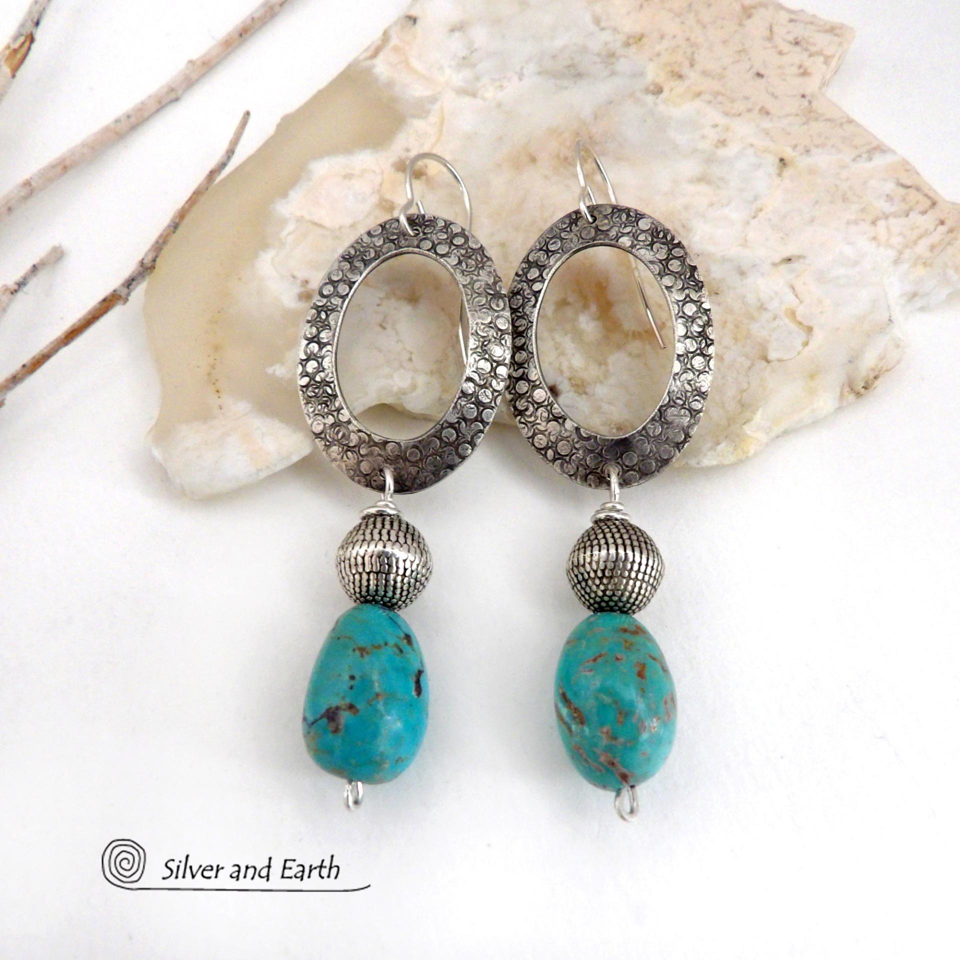 These handcrafted earrings feature hand stamped sterling silver oval hoops accented with natural turquoise stone nuggets and textured silver plated beads. They have a chic modern style with touch of southwestern flair that will coordinate beautifully with all wardrobe types. Handmade in the USA by Silver and Earth Jewelry. 