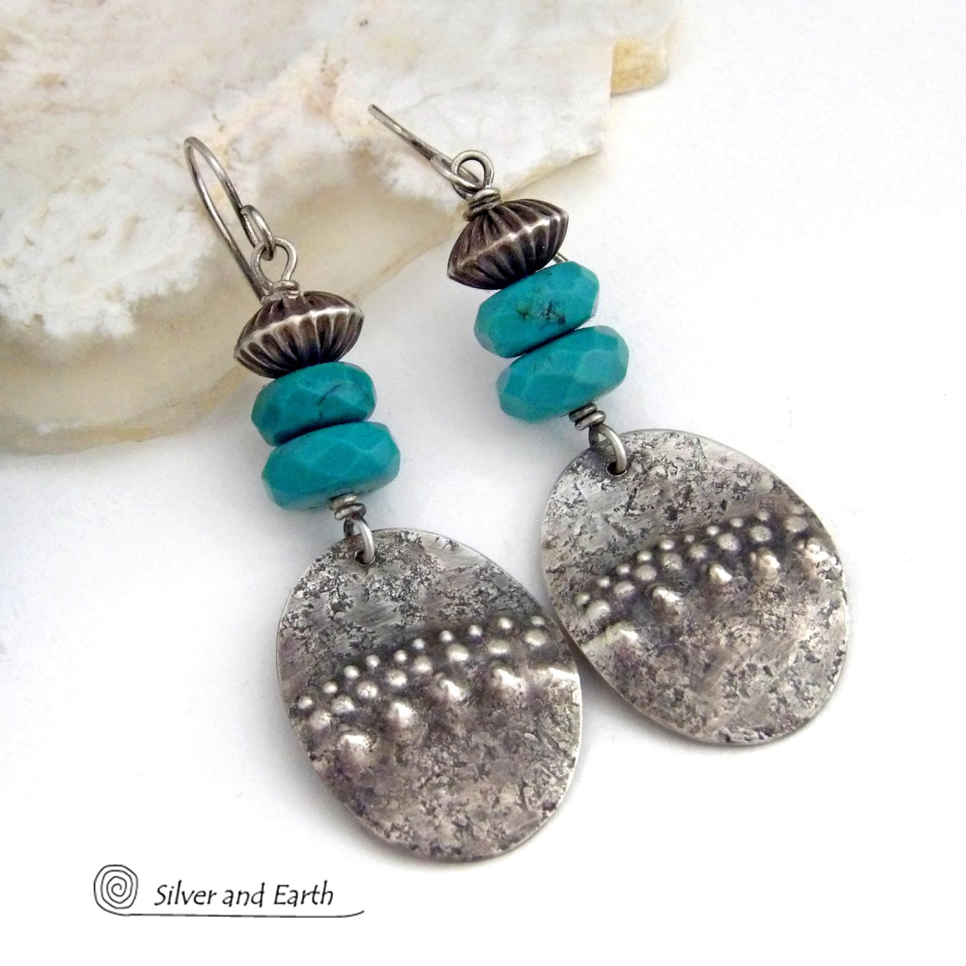 These handcrafted earrings feature sterling silver oval dangles with a hammered and hand stamped texture accented with faceted natural turquoise gemstones and oxidized sterling silver beads with a rich, corrugated texture and oxidized finish. They have a modern, southwestern style and are perfect for women that love to wear artisan handcrafted southwestern jewelry. Handmade in the USA by Silver and Earth jewelry, a New Mexico True Certified business. 