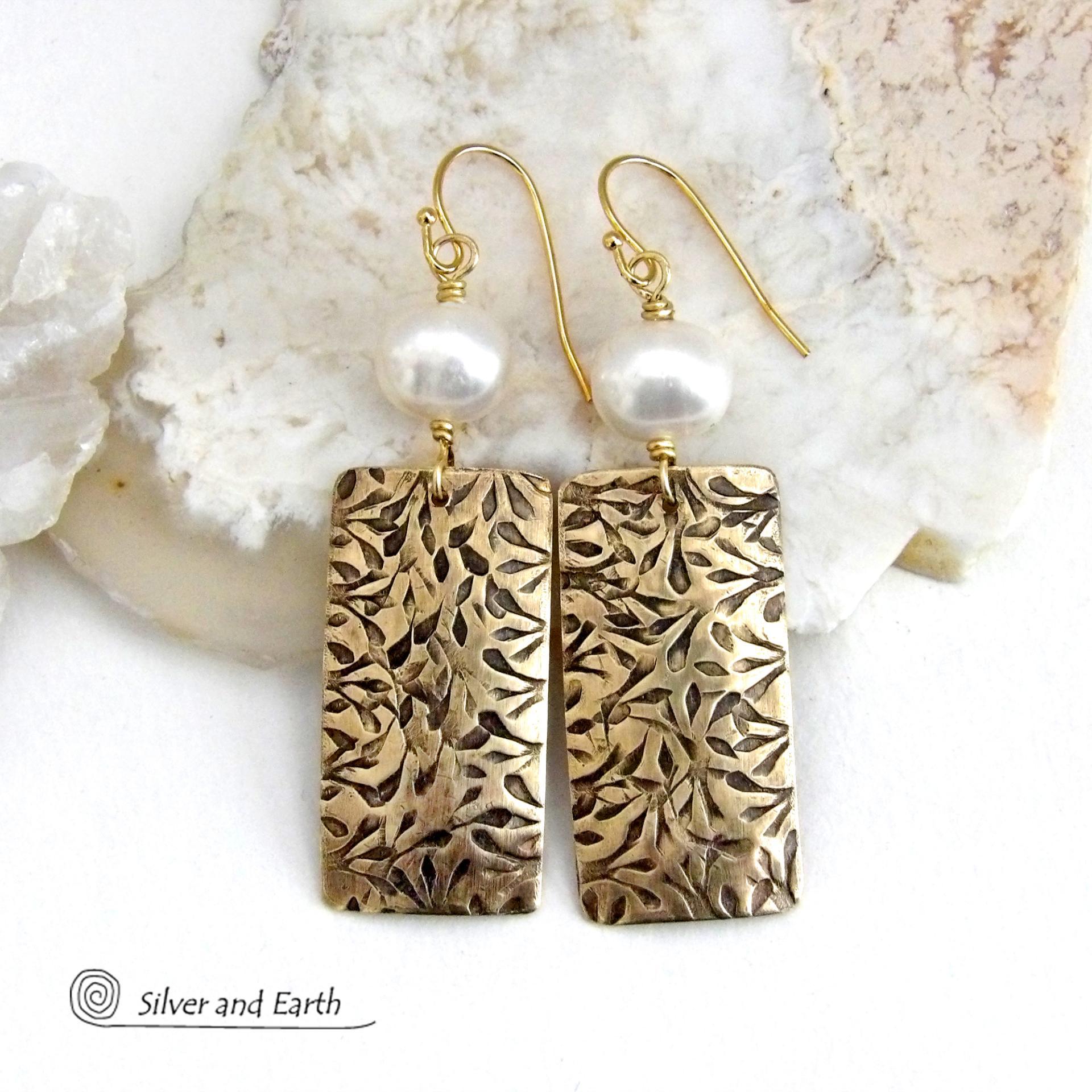 These handcrafted earrings feature gold brass rectangles with an intricate hand stamped texture accented with white freshwater pearls. They have a modern, elegant chic and feminine style that looks great dressed up or down. They'll make a great gift for couples celebrating their 21st wedding anniversary - brass is the traditional choice for this occasion. Also makes a great birthday gift for someone born in June - pearl is the birthstone for that month. Handmade in the USA by Silver and Earth Jewelry. 