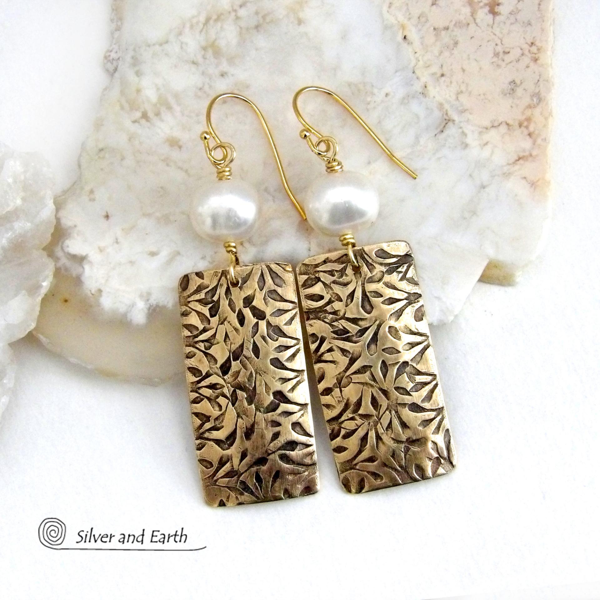 These handcrafted earrings feature gold brass rectangles with an intricate hand stamped texture accented with white freshwater pearls. They have a modern, elegant chic and feminine style that looks great dressed up or down. They'll make a great gift for couples celebrating their 21st wedding anniversary - brass is the traditional choice for this occasion. Also makes a great birthday gift for someone born in June - pearl is the birthstone for that month. Handmade in the USA by Silver and Earth Jewelry. 