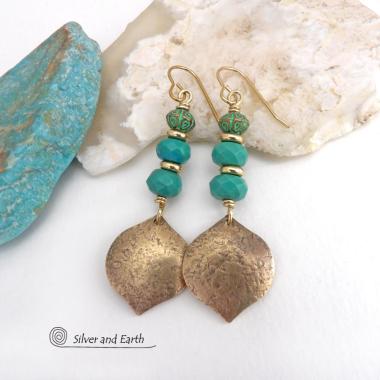 These handcrafted earrings feature gold brass dangles with a hammered organic silky texture accented with faceted genuine turquoise gemstones, tiny brass beads and blue-green patina beads with a tribal style pattern. They have an elegant modern style with a boho chic flair and will make a unique statement. Handmade in the USA by Silver and Earth Jewelry. 