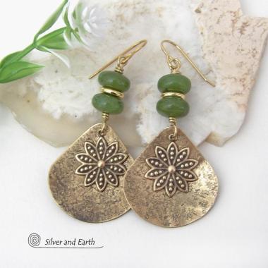 These handcrafted gold brass earrings have an earthy and modern nature-inspired charm. The design consists of brass fan-shaped dangles accented with Canadian green jade gemstones, brass flower charms and brass beads. The flowers have a lovely detailed texture and swing freely in front of the lightly hammered brass dangles. Perfect for your spring / summer wardrobe - or any time of year. They'll make a great gift for a nature and/or flower lover - or a nice addition to your own jewelry wardrobe. 