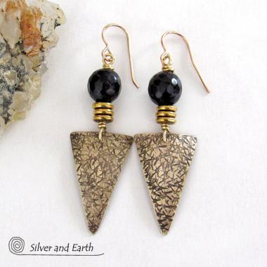 These gold brass triangle earrings have a hand stamped texture and are accented with black onyx gemstones above a stack of tiny brass beads. The stones have a faceted finish which gives off a natural sparkle and shine. Lightweight and comfortable to wear - they have a modern chic contemporary style that coordinates well with all wardrobes types. Handmade in the USA by Silver and Earth Jewelry.