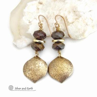 These handcrafted earrings feature gold brass dangles with a hammered organic texture accented with natural bronzite gemstones and shiny gold brass beads. The stones have a beautiful brown hue with a faceted finish which casts off a natural sparkle and shine. They have a modern chic style that coordinates beautifully with all wardrobe types - dressed up or down. A coordinating necklace is available that is sold separately.  Handmade in the USA by Silver and Earth Jewelry.