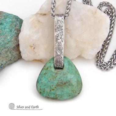 This one-of-a-kind pendant necklace features a beautiful chunky natural chrysocolla gemstone with a faceted finish. The stone is a beautiful shade of bluish-green which resembles turquoise. It hangs from a hand forged solid sterling silver bail with a lightly hammered organic texture. The stone is equally gorgeous on both sides, so I designed it to be reversible. (See all photos for alternate sides). Unique and one-of-a-kind, it's sure to make a statement. Makes a great gift for a natural stone lover - or a