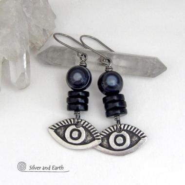 These unique earrings feature black eye agate and onyx stones accented with silver pewter "evil eye" charms. When cut at the right angle, this type of agate reveals a series of concentric rings that resembles the human eye. Evil eye symbolism has been around for centuries. The belief is that when worn -- evil eye jewelry will provide a level of protection against the envy and negative energy of others and perhaps bring the wearer good luck.