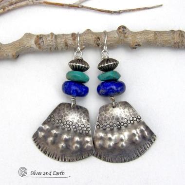 Bold and striking, these handcrafted earrings feature uniquely textured sterling silver accented with natural turquoise and lapis gemstones. They are topped off with Native style oxidized sterling silver beads with a rich, corrugated texture. They have a modern southwestern flair and are perfect for women that love to wear one-of-a-kind artisan handcrafted jewelry. Handmade in the USA by Silver and Earth - a New Mexico True Certified business.