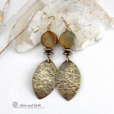 These handcrafted earrings feature textured gold brass dangles accented with natural Picasso jasper gemstones and hematite stone beads. The beads have an electroplated champagne gold tone finish which adds a touch of shimmer and shine. They have an earthy modern style that coordinates well with all wardrobe styles. Coordinating necklace is available and sold separately.