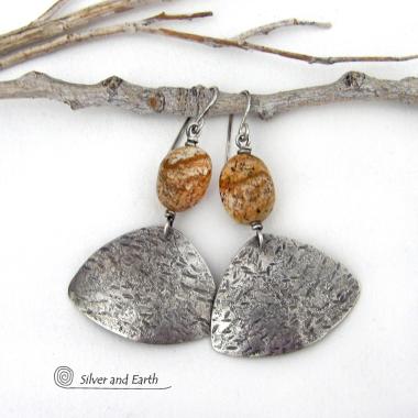 These handcrafted earrings feature natural picture jasper stones accented with textured sterling silver dangles. They have a modern, earthy design that looks great with all wardrobe styles. The stones have a natural pattern of brown streaks and black speckles against a tan background. I created the dangles out of solid sterling silver sheet; hammered them for an earth, organic texture; then oxidized them to enhance the detail. Earrings have a coordinating necklace sold separately. 