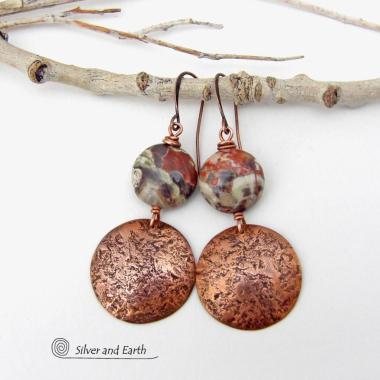 These handcrafted earrings feature natural rhyolite jasper stones accented with copper dangles with a rustic hammered texture. The stones have a natural earthy pattern with various shades of green, rusty orange, brown and cream. They have a casual and earthy style and will make a great gift for a natural stone lover - or a nice addition to your own jewelry wardrobe. Your choice of ear wires. Coordinating necklace sold separately. Handmade in the USA by Silver and Earth Jewelry.